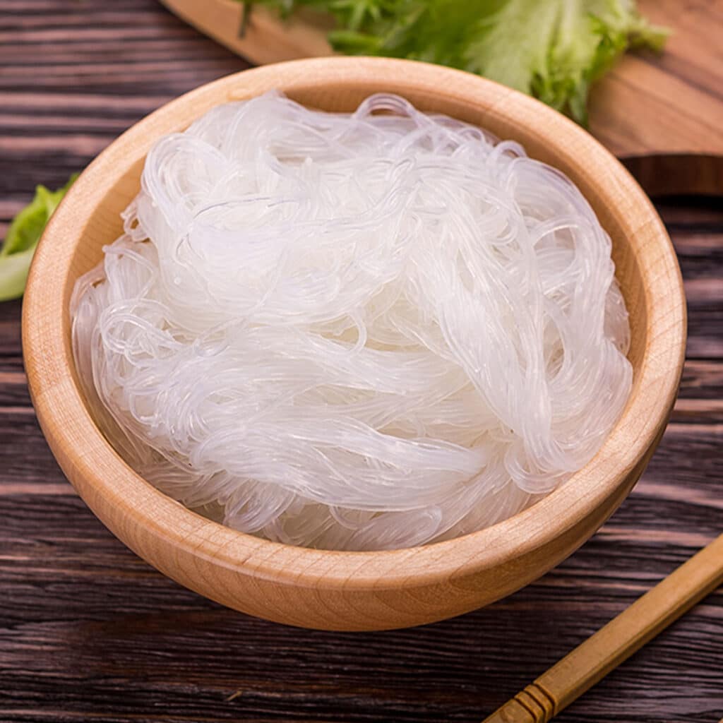 Rinse the rice noodles in cold water. It helps to remove any excess starch, which makes them stick together in the first place.