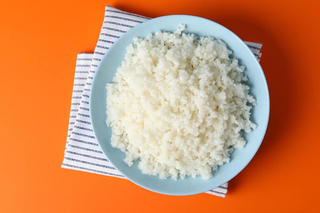 When the rice has been overcooked, the grains are usually mushy. It is the result of the grains splitting and releasing the starch they contain.