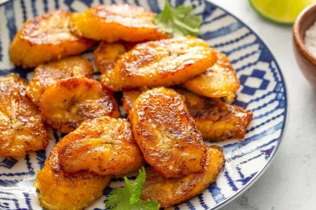 Pan-fried plantains serve as matching sides to a rich, thick beef stew.  These classic sides add more to every bite of saucy pork and beef dishes.