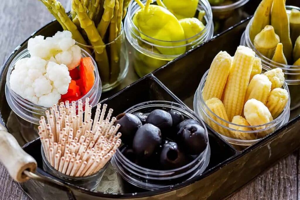 While a cheese platter is composed of varieties of cheese and their complements, a relish tray is made up of pickles, fresh vegetables, olives, and other bite-size foods.