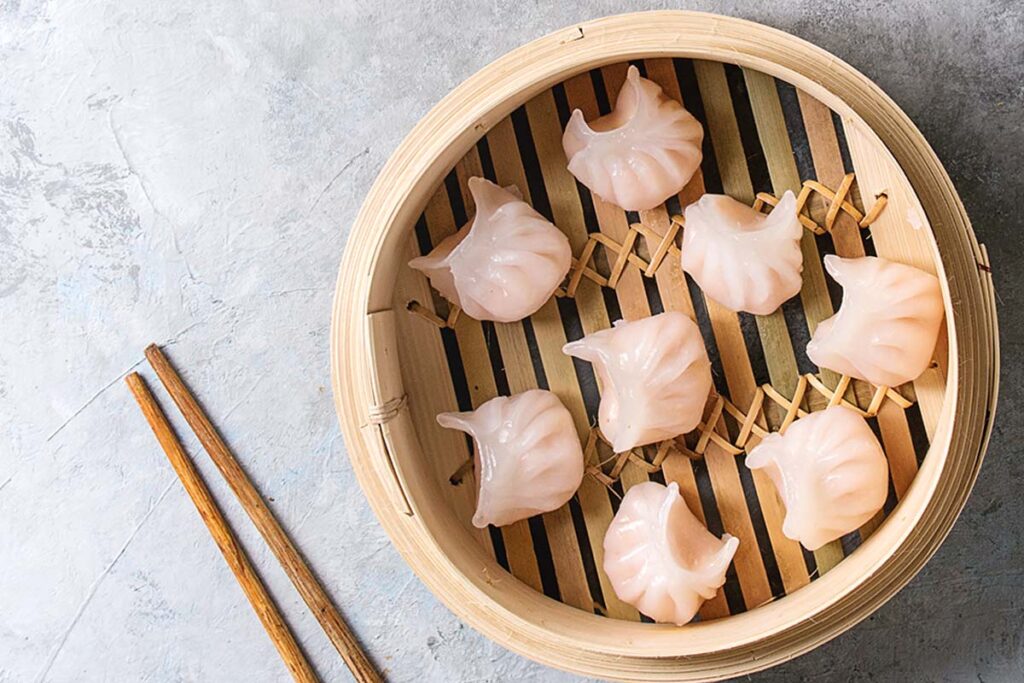 Har Gow (pronounced as "Ha-gow") are crescent-shaped dumplings. You can make the wrappers from wheat and tapioca starch translucent and should be constructed and closed with seven or ten pleats.