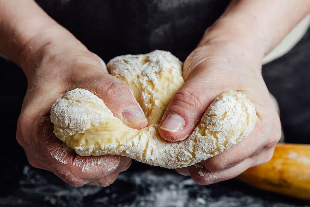 Handle the dough with caution. The overly handled dough can result to dry cookies. Overdeveloping the gluten is one contributing factor for moisture to be absorbed from the batter.