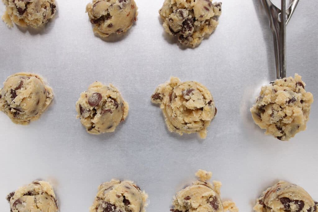 Strive to use a scooper when baking a batch of cookies and arrange tall mounds rather than flattening them on the baking sheet.