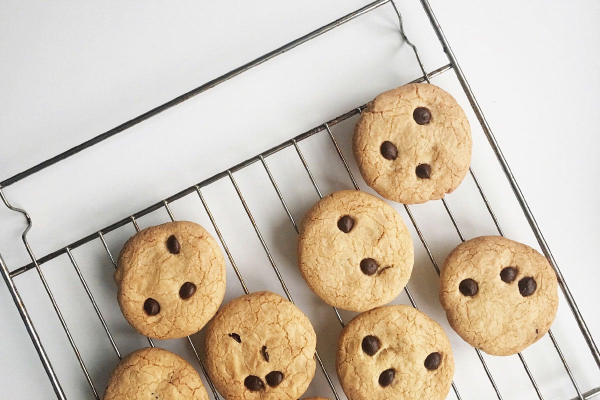 Let your cookies cool down to room temperature before storing them. It's beneficial to let them cool on a rack to distribute the air around them instead of sitting on a hot sheet while cooling.