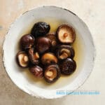 The benefits of soaking dried shiitake mushrooms in cold water for a more extended period yield mushrooms that are flavorful, incredibly firm, and velvety in texture.