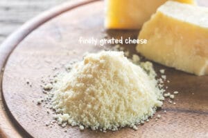 Using a box grater, use the fine edge or a Microplane and stir the finely grated cheese together by hand.