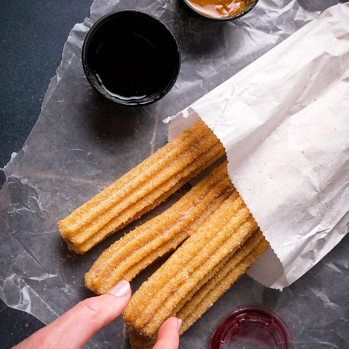 Churros are fried dough pastries that originate from Spain. They are traditionally made by piping dough into hot oil, resulting in a crispy on the outside and soft on the inside.