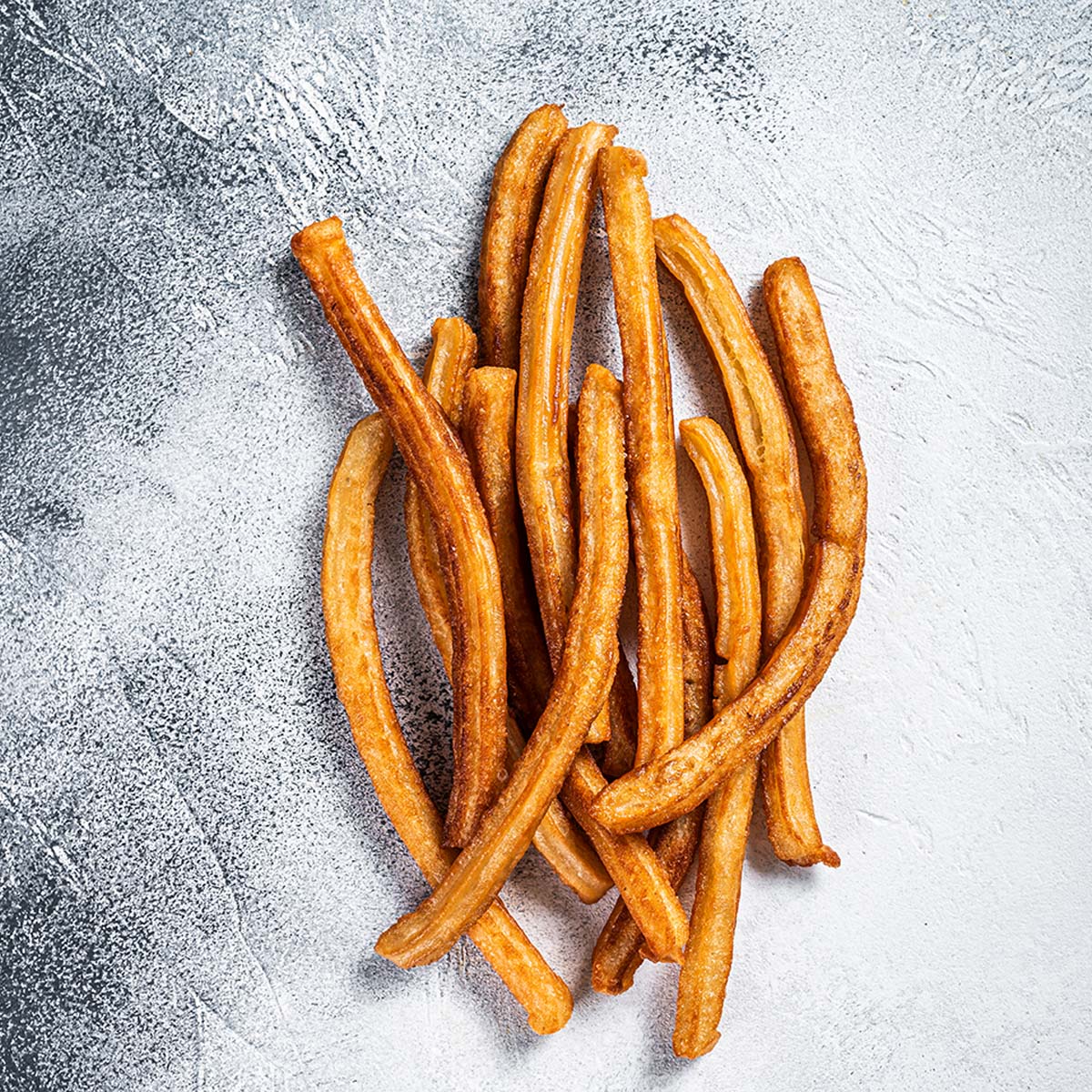Churros are fried food. Refrying them will make them greasy, and reheating in the microwave will make them soggy. There’s a right way and a wrong way to reheat churros like any other food.