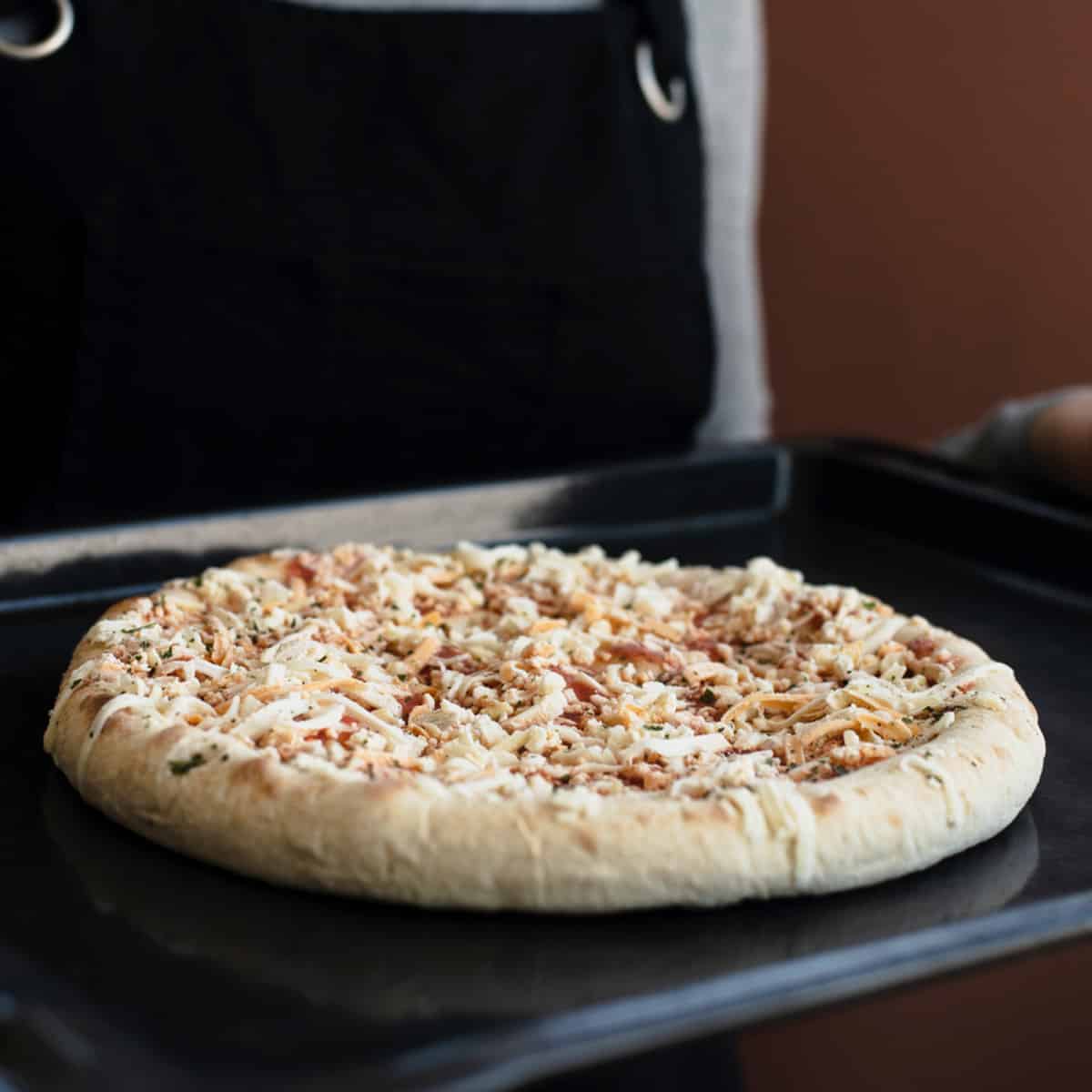 Pizzas made with frozen dough tend to be soft and fluffy because there is a lot of water in the dough.