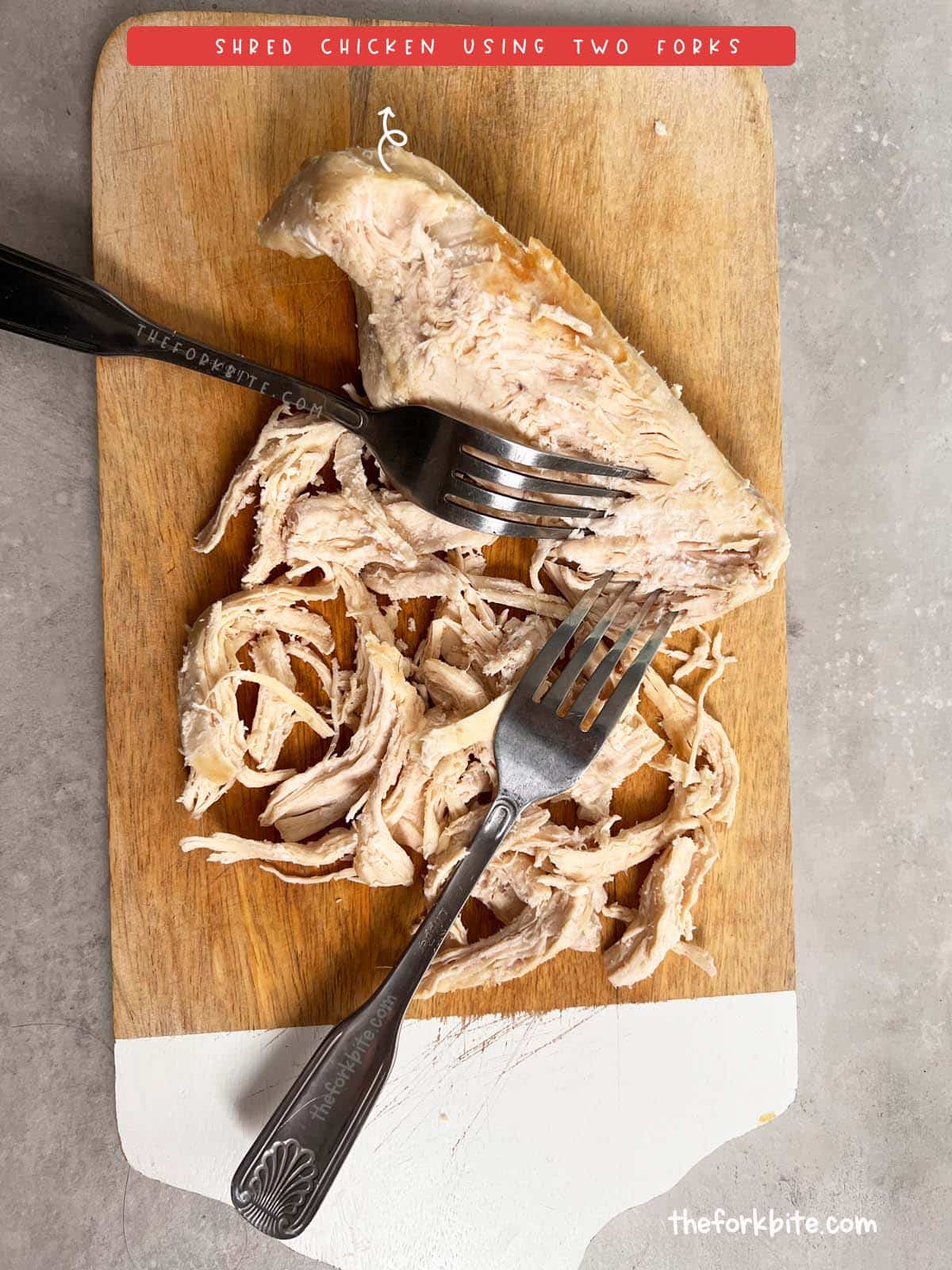Place the cooked chicken on a cutting board and use the two forks to pull the meat apart in opposite directions. This method works well for shredded chicken used in salads, tacos, or other dishes where small pieces are desired.