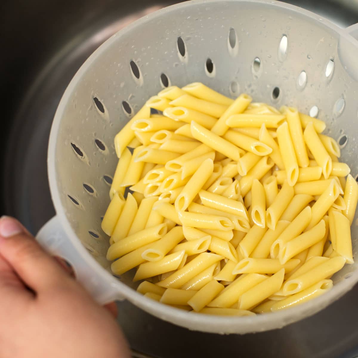 It’s important to remove enough water to prevent the pasta from being too watery but not so much that it is allowed to dry off and cool.