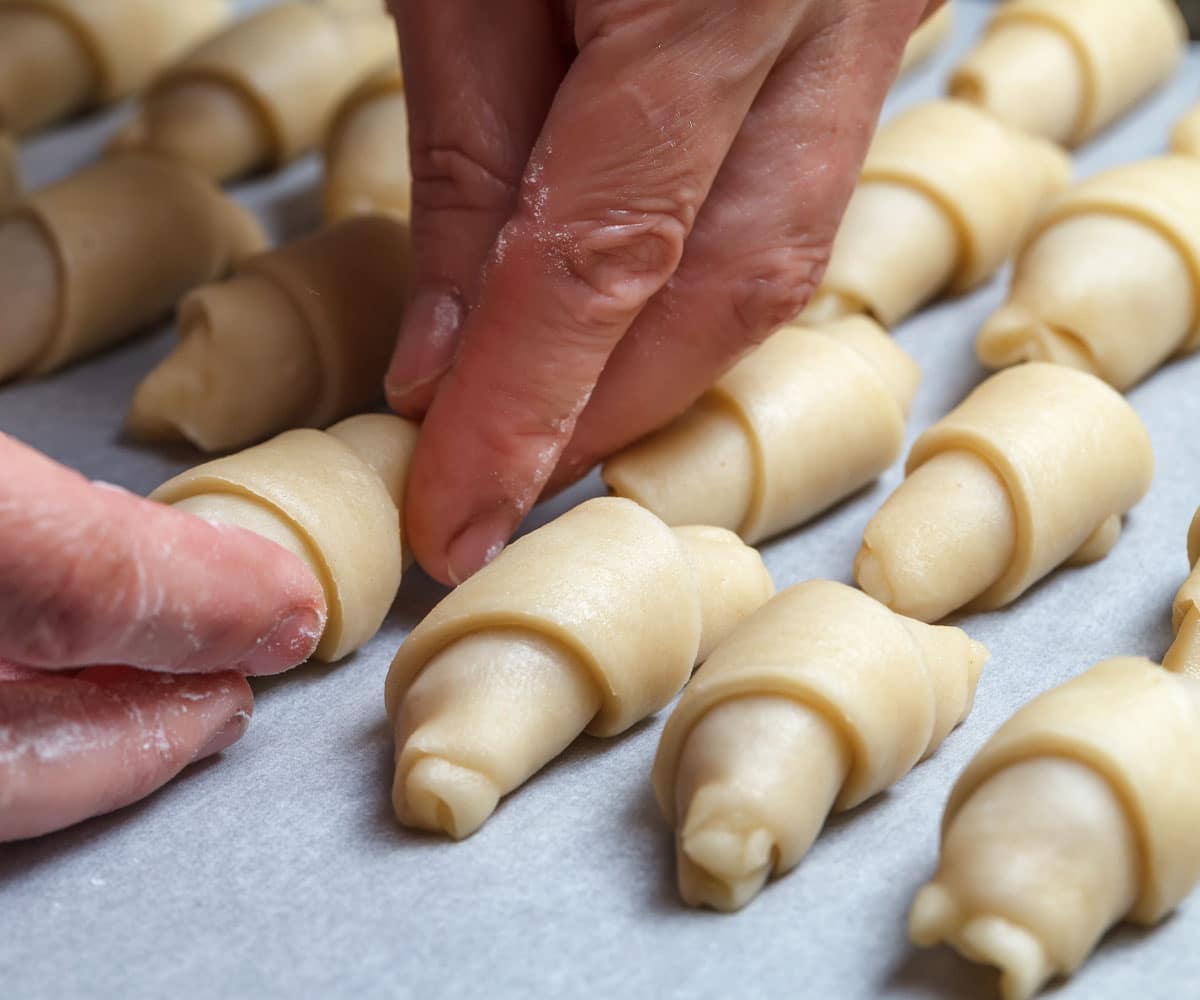 While both crescent rolls and croissants are made with mixed dough, rolled out, and baked, the preparation methods for these two types of pastry differ in how the dough is shaped and layered.