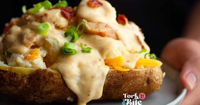 Loaded seafood baked potato is a delicious and hearty dish comprised of a baked potato filled with a generous amount of seafood and toppings. This dish perfectly combines crispy potato skin and a soft and creamy interior, combined with the rich flavors of seafood and seasonings.