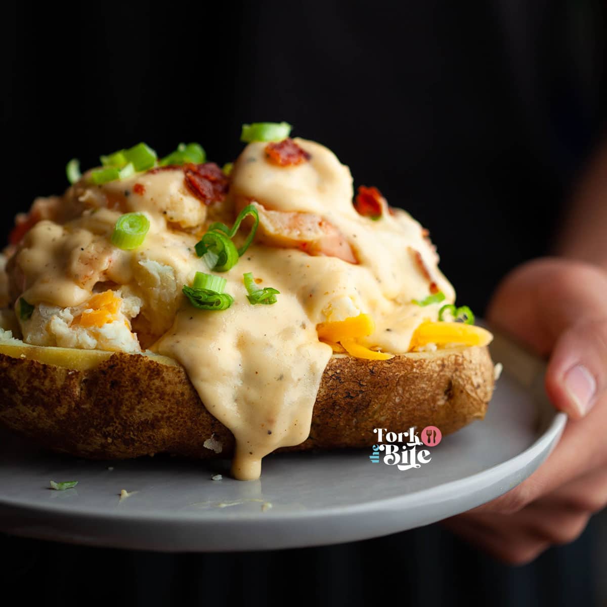 Loaded seafood baked potato is a delicious and hearty dish comprised of a baked potato filled with a generous amount of seafood and toppings. This dish perfectly combines crispy potato skin and a soft and creamy interior, combined with the rich flavors of seafood and seasonings.