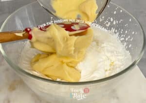 Gently fold the whipped cream into the chilled pudding mixture, ensuring no streaks are left behind.
