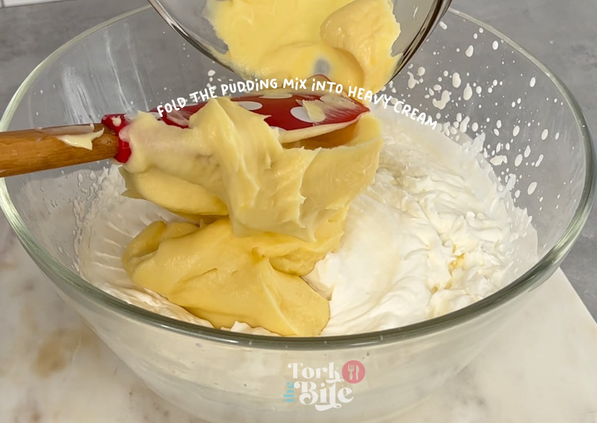 Gently fold the whipped cream into the chilled pudding mixture, ensuring no streaks are left behind.