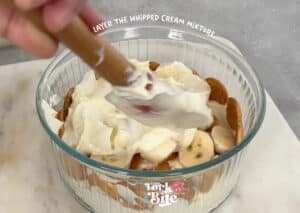 Add a layer of the pudding/whipped cream mixture to the bananas. Be sure to spread the pudding evenly to cover the bananas and wafers completely.