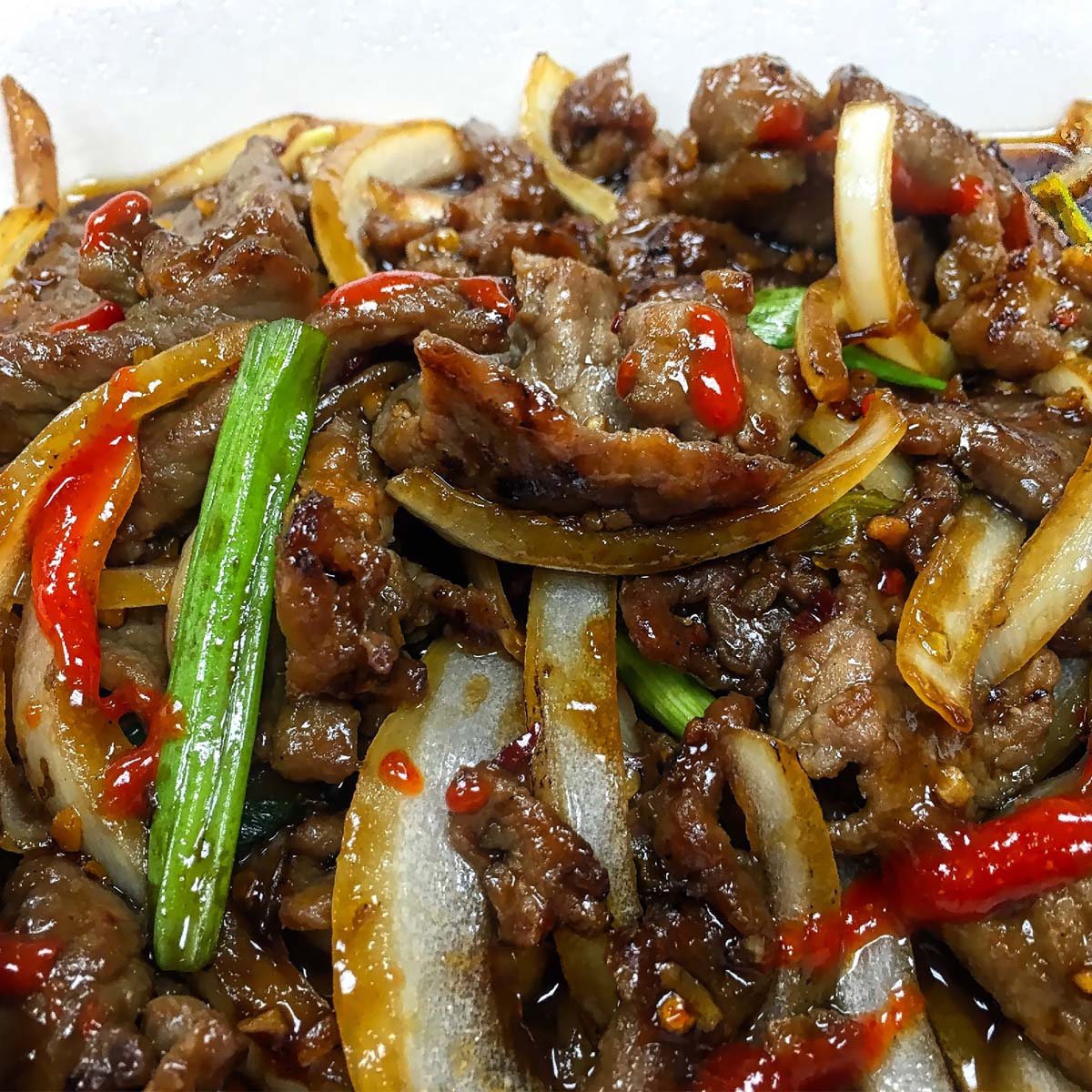 Moo Shu Beef is a classic Chinese dish that features tender slices of marinated beef stir-fried with a colorful mix of vegetables and served with a delicious, savory hoisin sauce.