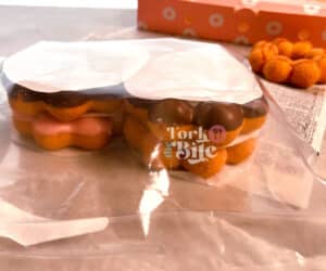 Use parchment paper to layer the donuts and wrap the entire stack.