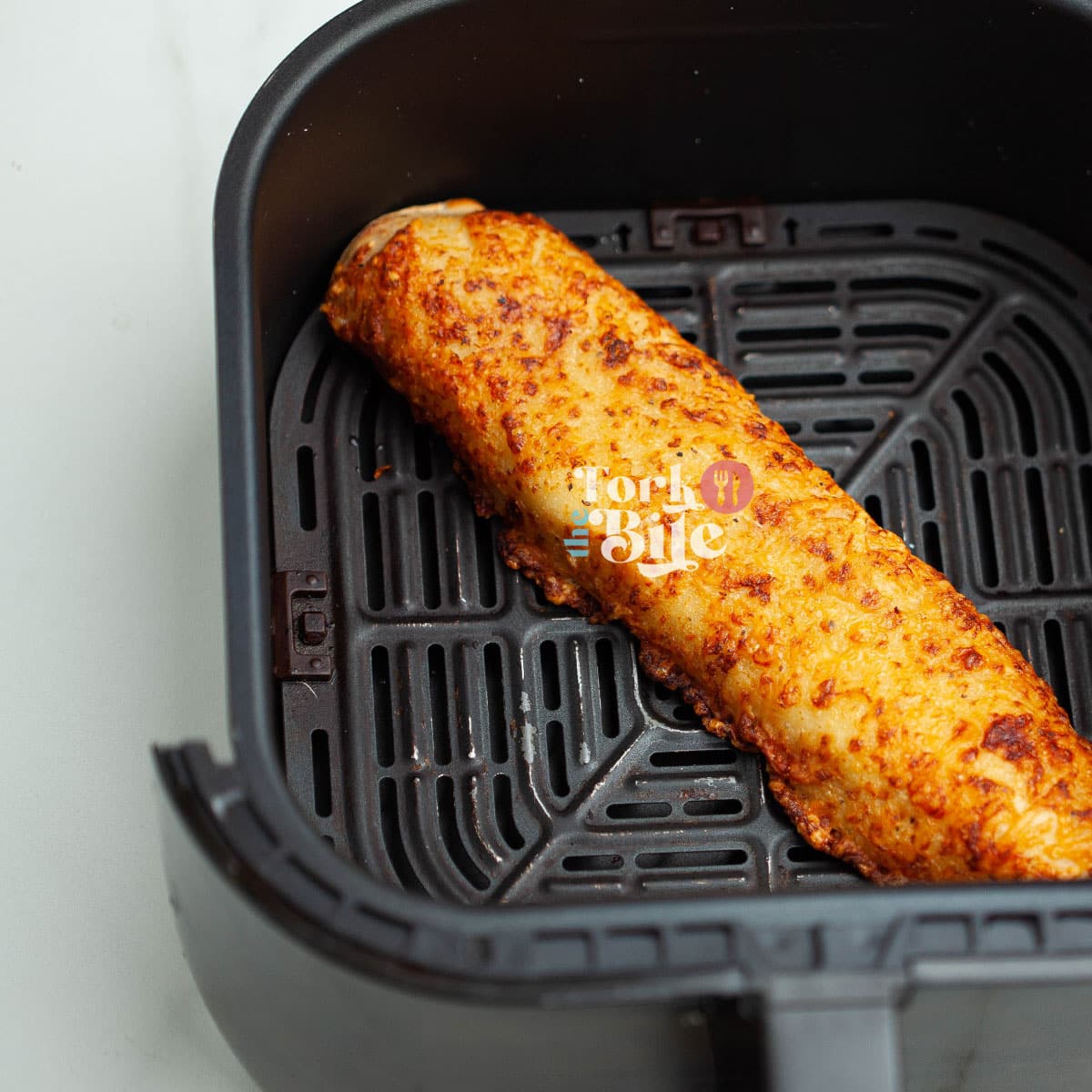 The air fryer is the best method for reheating Costco chicken bakes, as it helps retain the crust's crispiness while warming the filling evenly.