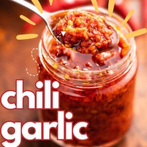 Chili Garlic Sauce in a bowl with fresh chili and garlic on the side