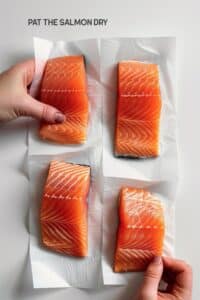 Drying a salmon fillet with a paper towel before baking - a step for ensuring a crispy texture.