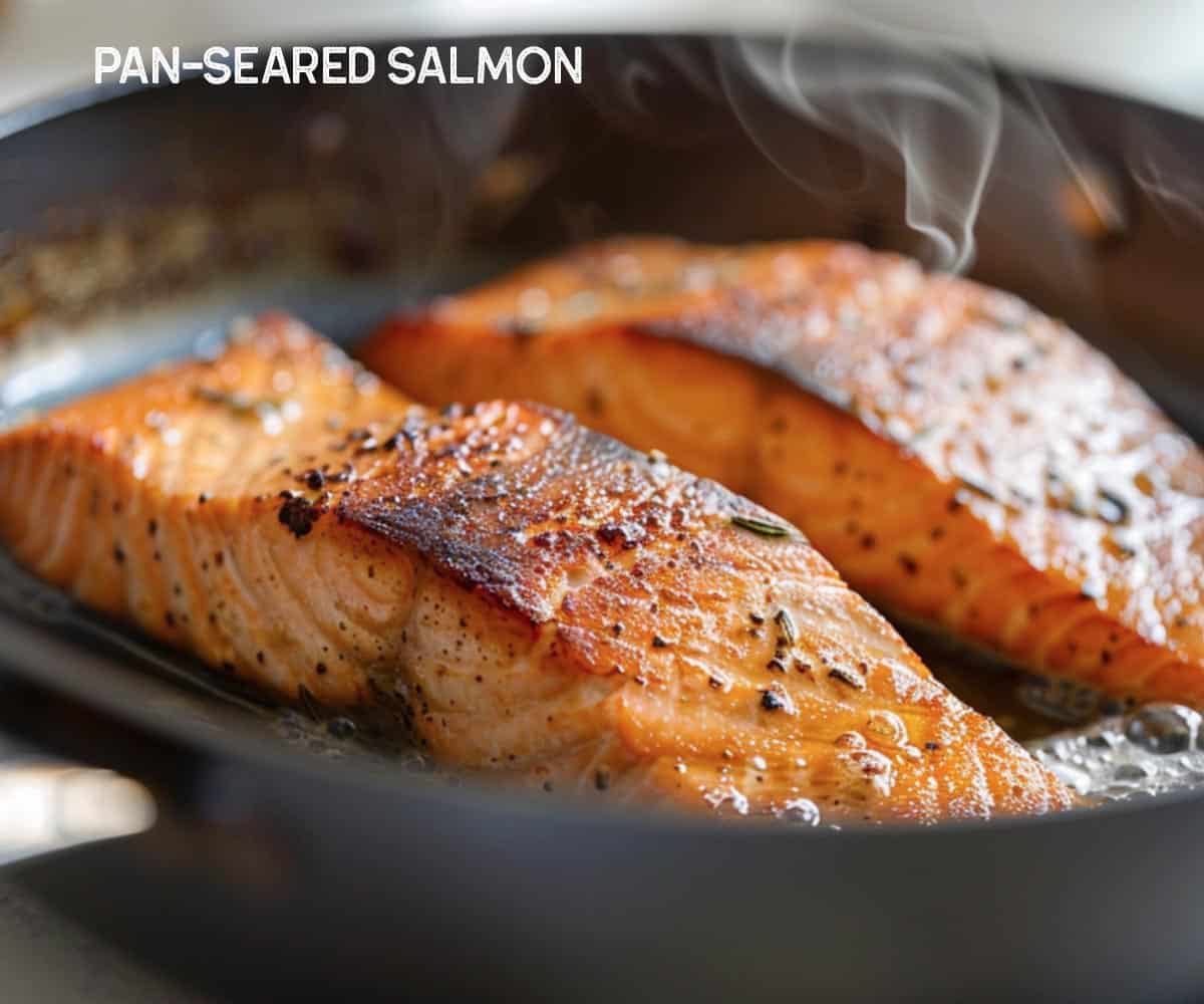 Close-up of salmon searing in a pan with sizzling oil