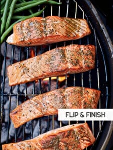 Flipping salmon on the grill for even cooking and a perfect sear.