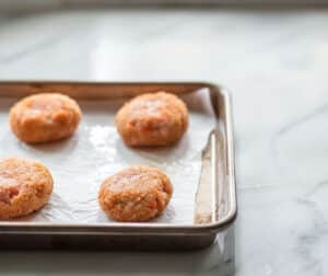 Shaping the salmon croquette mixture ensures even cooking and prevents sticking.