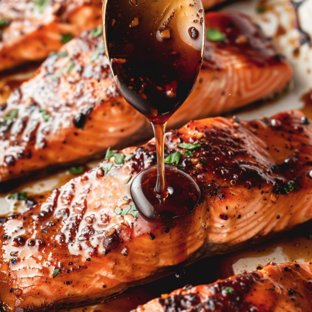 Perfectly cooked honey glazed salmon fillet with a glistening sauce, ready to be served.