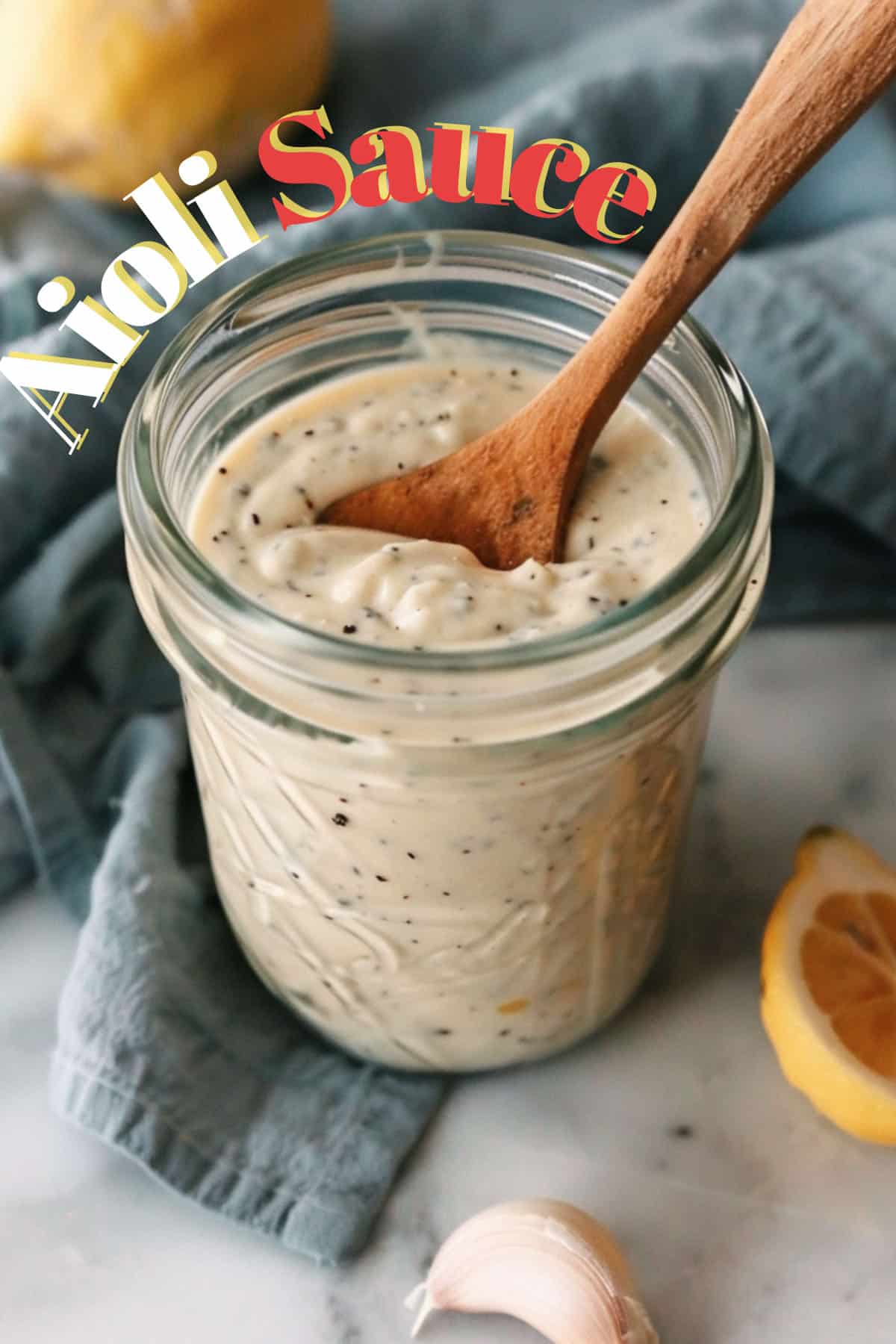 Fresh, homemade lemon aioli in a glass jar with a spoon, offering a flavorful upgrade compared to store-bought options.