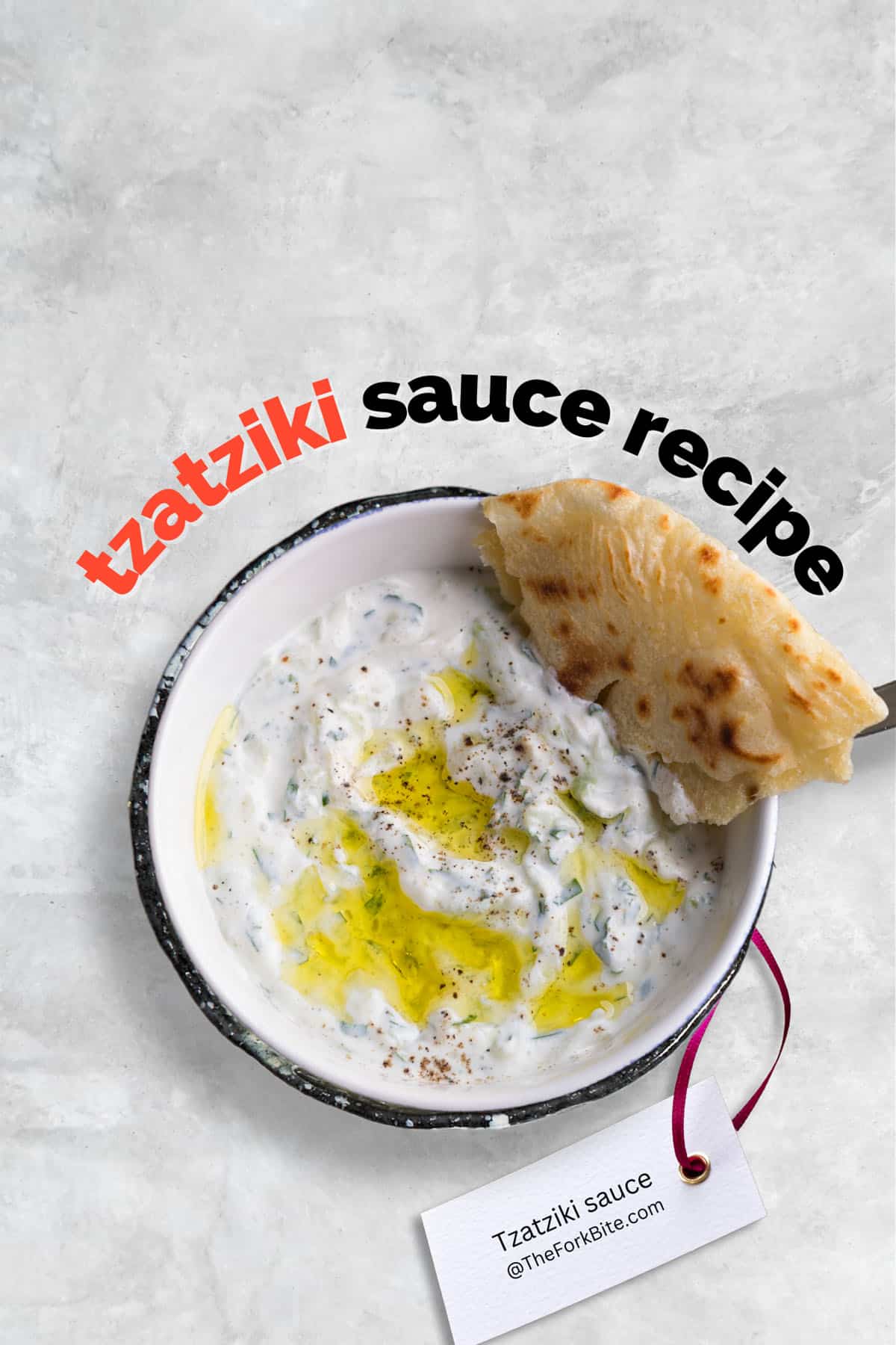A bowl of creamy tzatziki sauce with a drizzle of olive oil and a sprinkle of fresh dill.