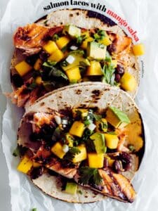 Colorful air fryer salmon tacos with vibrant mango salsa, ready to be enjoyed.
