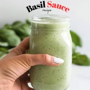 Creamy, green basil sauce in a mason jar, ready to be drizzled on various foods.