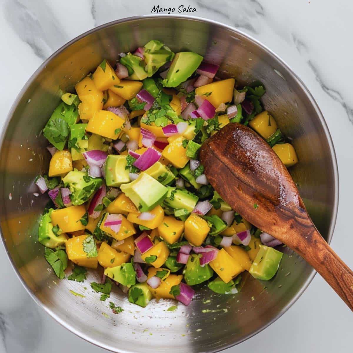 A bowl of homemade mango salsa, the perfect topping for air fryer salmon tacos.