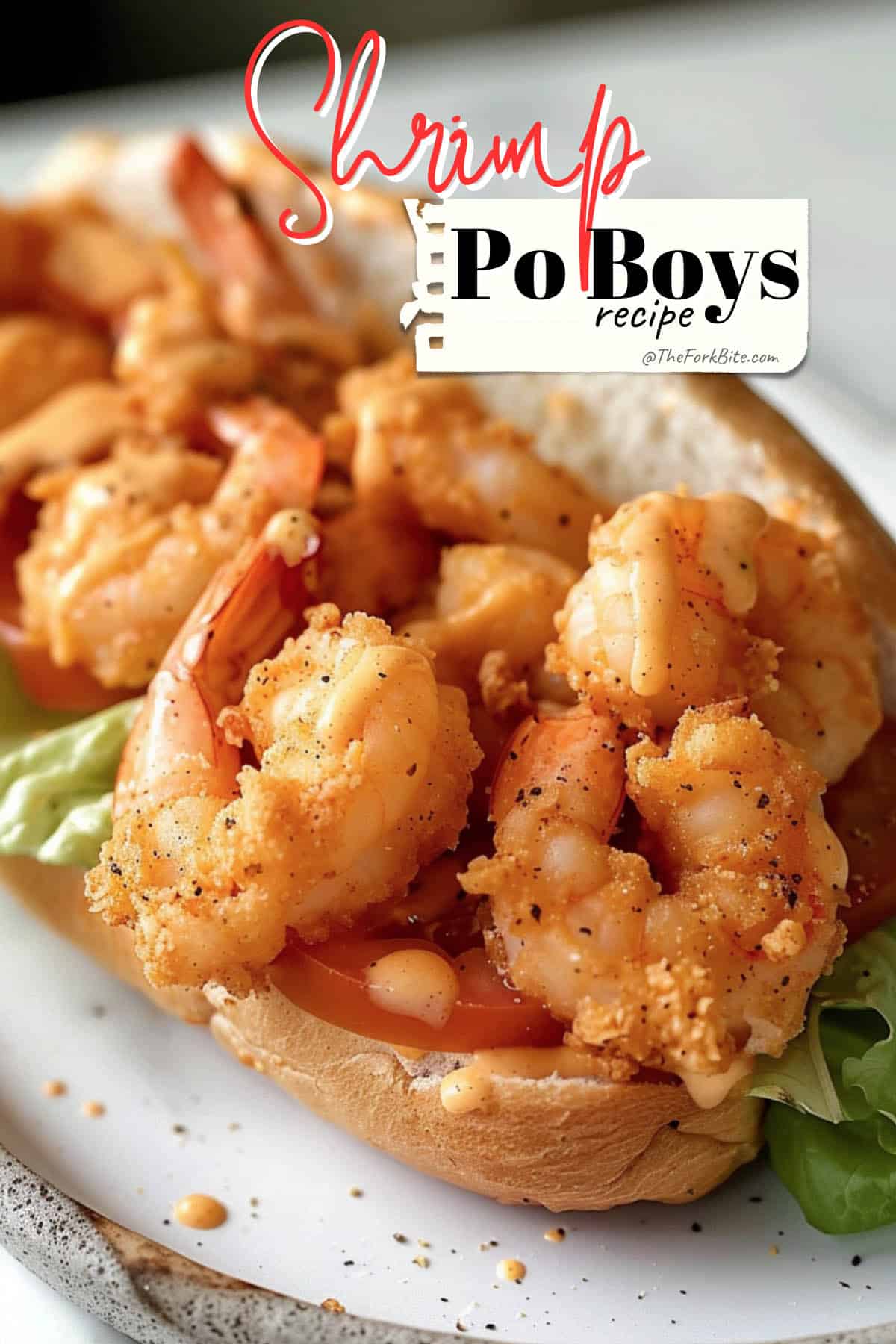 Close-up photo of a shrimp po' boy sandwich with crispy shrimp, shredded lettuce, remoulade sauce, on a toasted French roll.